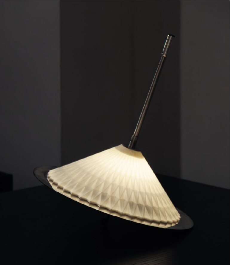Damavand floor light leaning in a dark interior