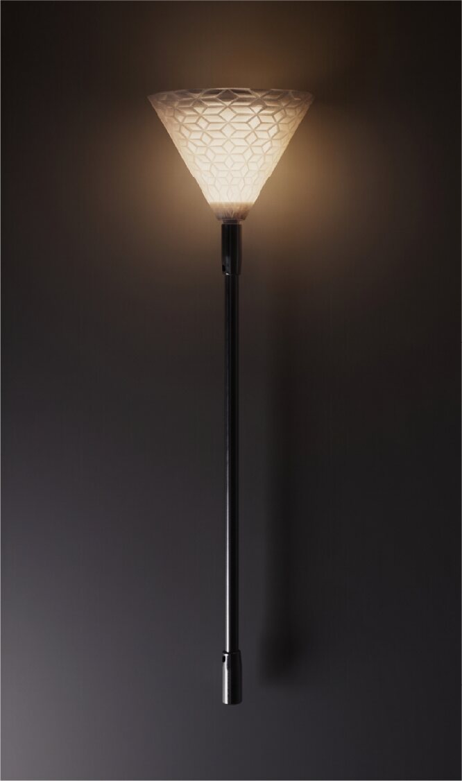 Tall Laleh light glowing vertically against a dark wall