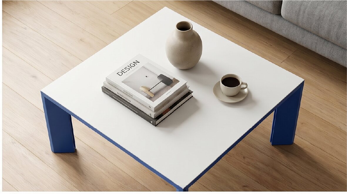 Blue and white Rija Table viewed from above with books and ceramics